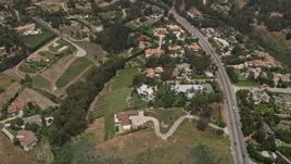 5K aerial stock footage tilt to a bird's eye view of mansions and vineyards in the hills, Malibu, California Aerial Stock Footage | AX42_096