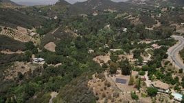 5K aerial stock footage fly over Kanan Dume Road to approach hillside mansions in Malibu, California Aerial Stock Footage | AX42_098E