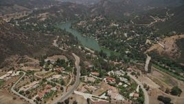 5K aerial stock footage fly over spacious upscale homes to approach Malibu Lake, Agoura Hills, California Aerial Stock Footage | AX42_112E
