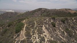 5K aerial stock footage of flying low over ridges in the mountains, Santa Monica Mountains, California Aerial Stock Footage | AX42_116E