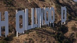 4K aerial stock footage of a slow, close flyby of the Hollywood Sign, Los Angeles, California Aerial Stock Footage | AX43_002