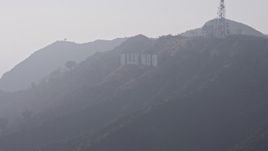 4K aerial stock footage flying by Hollywood Sign in fog, Los Angeles, California Aerial Stock Footage | AX43_005