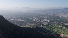 4K aerial stock footage approaching, flying over Hollywood Sign, reveal Walt Disney Studios, Forest Lawn Cemetery in Burbank, Los Angeles, California Aerial Stock Footage | AX43_006
