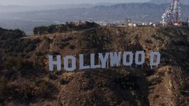 4K aerial stock footage approaching and flying by the world famous Hollywood Sign, Los Angeles, California Aerial Stock Footage | AX43_009