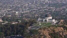 4K aerial stock footage flying by the Griffith Observatory overlooking the city of Los Angeles, California Aerial Stock Footage | AX43_014