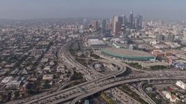 4K aerial stock footage orbiting heavy traffic in the 110/10 interchange, and tilt to reveal the Los Angeles Convention Center and skyscrapers, Downtown Los Angeles, California Aerial Stock Footage | AX43_021