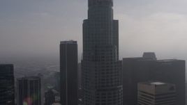4K aerial stock footage flying by US Bank Tower, and over City National Plaza and Paul Hastings  Tower on a foggy day, Downtown Los Angeles, California Aerial Stock Footage | AX43_027