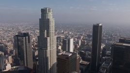 4K aerial stock footage flying between US Bank Tower and Aon Center to focus on city sprawl in the background, Downtown Los Angeles, California Aerial Stock Footage | AX43_033