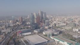 4K aerial stock footage tilting from heavy rush hour traffic on I-110 to reveal Staples Center, Ritz-Carlton and Downtown Los Angeles skyscrapers in California Aerial Stock Footage | AX43_034