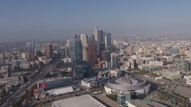 4K aerial stock footage tilting from heavy rush hour traffic on I-110 to reveal Staples Center, Ritz-Carlton and Downtown Los Angeles skyscrapers in California Aerial Stock Footage | AX43_034E