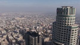 4K aerial stock footage tracking top of US Bank Tower and fly away from the skyscraper, Downtown Los Angeles, California Aerial Stock Footage | AX43_038