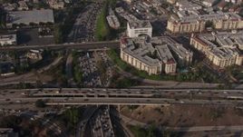 4K aerial stock footage of bird's eye of traffic on the I-110 / 101 interchange, panning to apartment buildings, Downtown Los Angeles, California Aerial Stock Footage | AX43_042