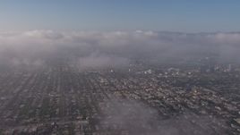 4K aerial stock footage flying over marine layer and a large break in the clouds, Los Angeles Aerial Stock Footage | AX43_053