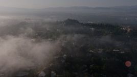 4K aerial stock footage flying over marine layer clouds to reveal hillside homes and radio tower in Beverly Hills, California Aerial Stock Footage | AX43_058E