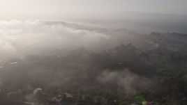 4K aerial stock footage approaching the marine layer rolling over upscale, hillside homes in Beverly Hills, California Aerial Stock Footage | AX43_060