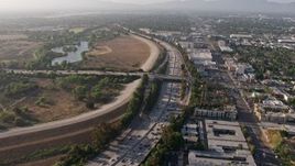 4K aerial stock footage following heavy I-405 traffic by Woodley Park, Van Nuys, California, approach the Burbank Boulevard overpass Aerial Stock Footage | AX43_065