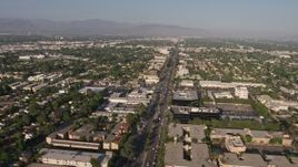 4K aerial stock footage flying by suburban neighborhoods, busy city streets, and office buildings, Van Nuys, California Aerial Stock Footage | AX43_067