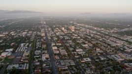 4K aerial stock footage flying by urban neighborhoods in Van Nuys, California, sunset Aerial Stock Footage | AX44_001