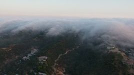 4K aerial stock footage of fog rolling in over the hills in Sherman Oaks, California, sunset Aerial Stock Footage | AX44_005