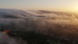 4K aerial stock footage flying over marine layer above the hills, Studio City, California, sunset Aerial Stock Footage | AX44_012