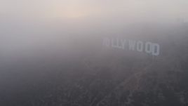 4K aerial stock footage orbiting Hollywood Sign and radio tower cloaked in Marine Layer, California, sunset Aerial Stock Footage | AX44_023E