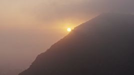 4K aerial stock footage of the setting sun through the marine layer, Hollywood Hills, California Aerial Stock Footage | AX44_025
