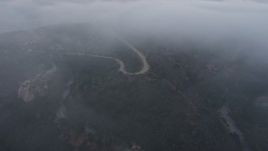 4K aerial stock footage of winding roads in fog, Hollywood Hills, California, sunset Aerial Stock Footage | AX44_029E