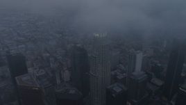 4K aerial stock footage of a wide angle descending through marine layer toward Downtown Los Angeles, twilight Aerial Stock Footage | AX44_037