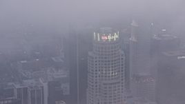 4K aerial stock footage of US Bank Tower covered in marine layer, twilight, Downtown Los Angeles Aerial Stock Footage | AX44_041