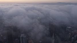 4K aerial stock footage of city covered in marine layer, Downtown Los Angeles, sunset Aerial Stock Footage | AX44_042E