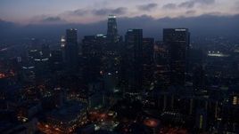4K aerial stock footage approaching Downtown Los Angeles skyline below marine layer, twilight Aerial Stock Footage | AX44_068E