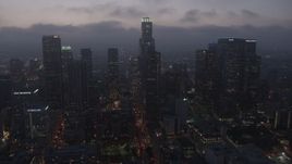 4K aerial stock footage flying by skyscrapers under marine layer, Downtown Los Angeles, twilight Aerial Stock Footage | AX44_069