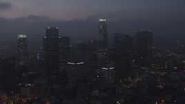 4K aerial stock footage flying by skyscrapers below marine layer, Downtown Los Angeles, twilight Aerial Stock Footage | AX44_071