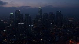 4K aerial stock footage flying by skyscrapers below marine layer, Downtown Los Angeles, twilight Aerial Stock Footage | AX44_071E