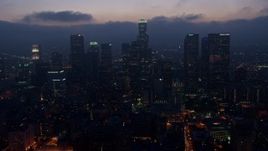 4K aerial stock footage flying by skyscrapers below marine layer, Downtown Los Angeles, twilight Aerial Stock Footage | AX44_073
