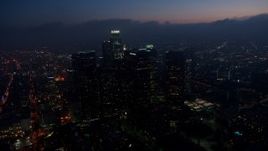 4K aerial stock footage flying by skyscrapers tracking US Bank Tower, Downtown Los Angeles, twilight Aerial Stock Footage | AX44_074