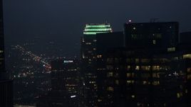 4K aerial stock footage flying by Figueroa at Wilshire skyscraper, Downtown Los Angeles, twilight Aerial Stock Footage | AX44_075