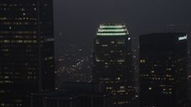 4K aerial stock footage of a medium shot flying by skyscrapers, Downtown Los Angeles, twilight Aerial Stock Footage | AX44_076