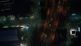4K aerial stock footage of bird's eye of city streets and skyscrapers, Downtown Los Angeles, night Aerial Stock Footage | AX44_086