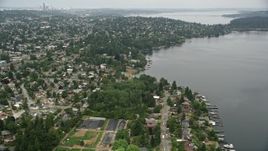 5K aerial stock footage of suburban homes near the lake, Pritchard Island Beach park, Rainier Beach, Washington Aerial Stock Footage | AX45_004