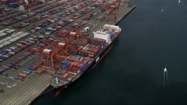 5K aerial stock footage approaching a cargo ship loading containers at Port of Seattle, Washington Aerial Stock Footage | AX45_016E