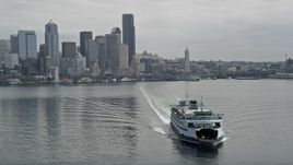 5K aerial stock footage tracking a ferry sailing away from Downtown Seattle skyline, Washington Aerial Stock Footage | AX45_021E