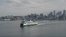 5K aerial stock footage ferry sailing Elliott Bay, reveal the Space Needle and Downtown Seattle, Washington Aerial Stock Footage | AX45_025E