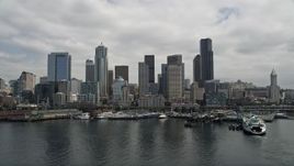 5K aerial stock footage flying by the skyline and Seattle Great Wheel on Pier 57, Downtown Seattle, Washington Aerial Stock Footage | AX45_034E
