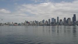 5K aerial stock footage tilting from Elliott Bay to reveal Downtown Seattle skyline, Washington Aerial Stock Footage | AX45_038