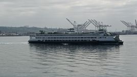 5K aerial stock footage flying beside a ferry sailing Elliott Bay, Seattle Aerial Stock Footage | AX45_046