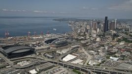 5K aerial stock footage approaching Safeco and CenturyLink Fields, and pan toward skyscrapers in Downtown Seattle, Washington Aerial Stock Footage | AX45_063