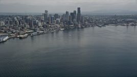 5K aerial stock footage tilting from Elliott Bay to reveal the skyline of Downtown Seattle, Washington Aerial Stock Footage | AX45_071