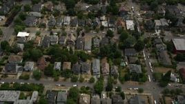 5K aerial stock footage flying over urban homes and reveal a high school, Central Seattle, Washington Aerial Stock Footage | AX45_078