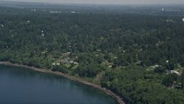 5K aerial stock footage tilt from railroad tracks on the shore to reveal homes, Shoreline, Washington Aerial Stock Footage | AX45_115